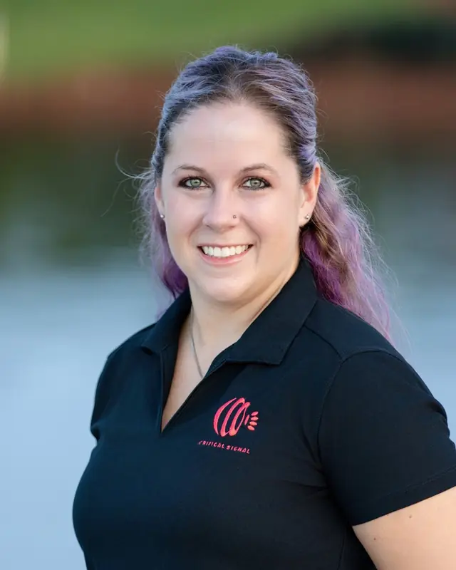 Jennifer Daly outdoors in a Critical Signal polo shirt.
